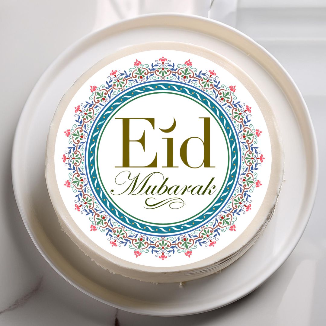 Decorative cake with 'Eid Mubarak' text on a white plate