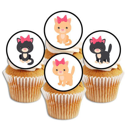 four cupcakes with white icing on a white background. The cakes are topped with edible cupcake toppers featuring cute cat illustrations