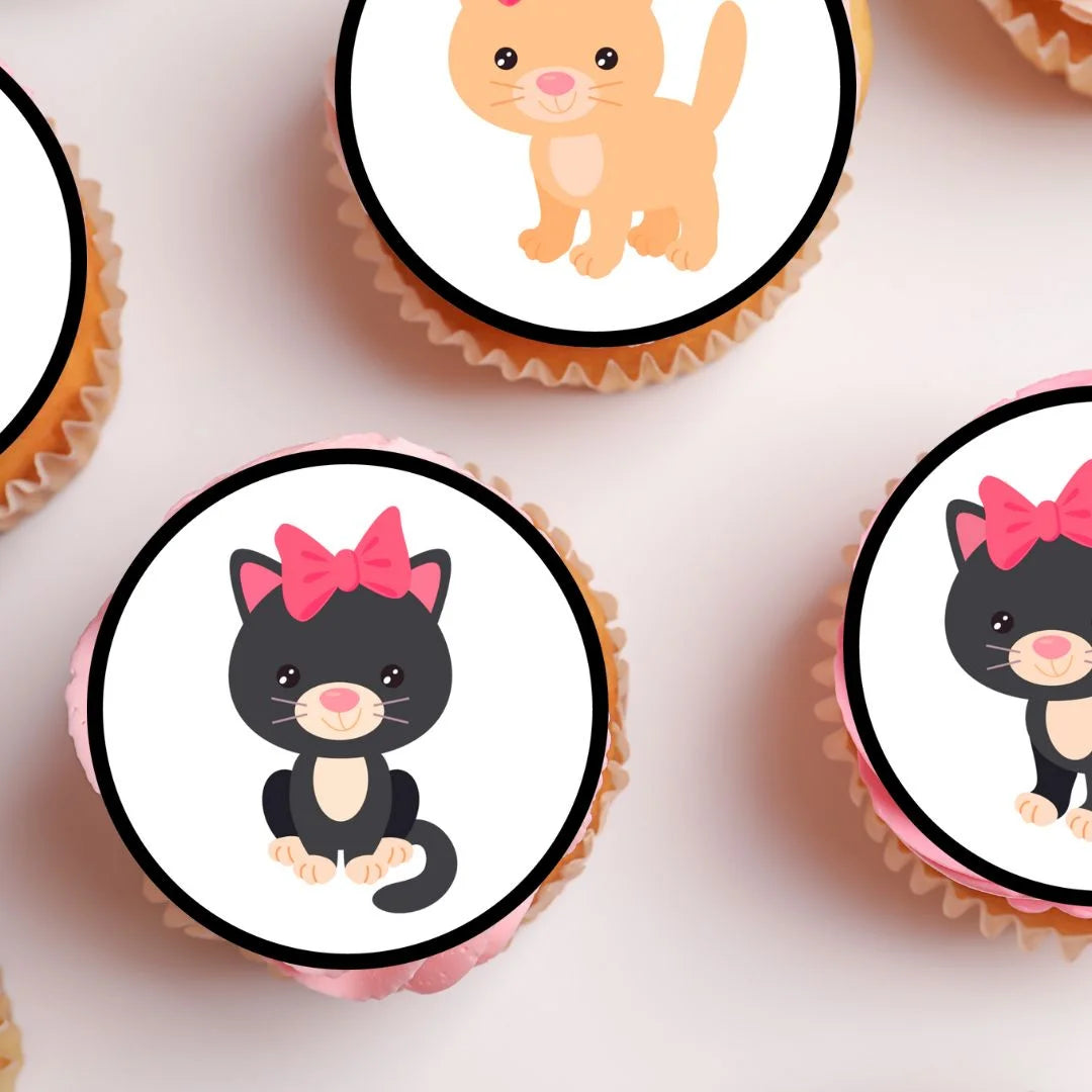 close up view of edible cute cat cake toppers on top of sponge cupcakes