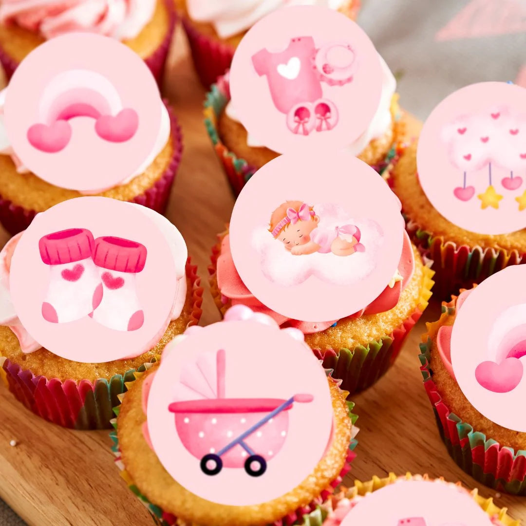 close up of Cian's Cupcake Toppers pink girl themed toppers on frosted cupcakes