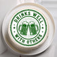 Cake with 'Drinks Well with Others' text and beer mugs design on a white background