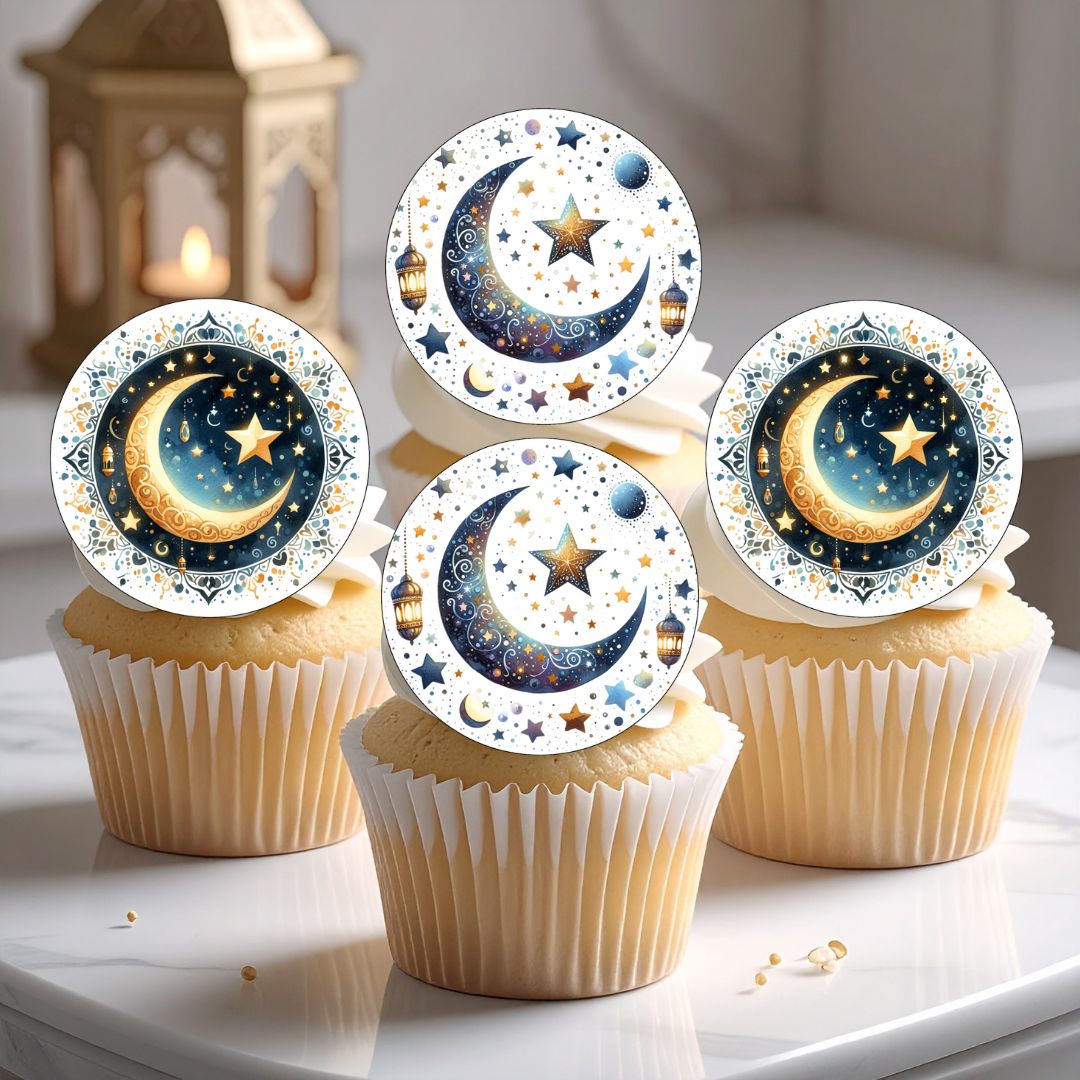 Cupcakes with star and moon designs on top on a white surface.