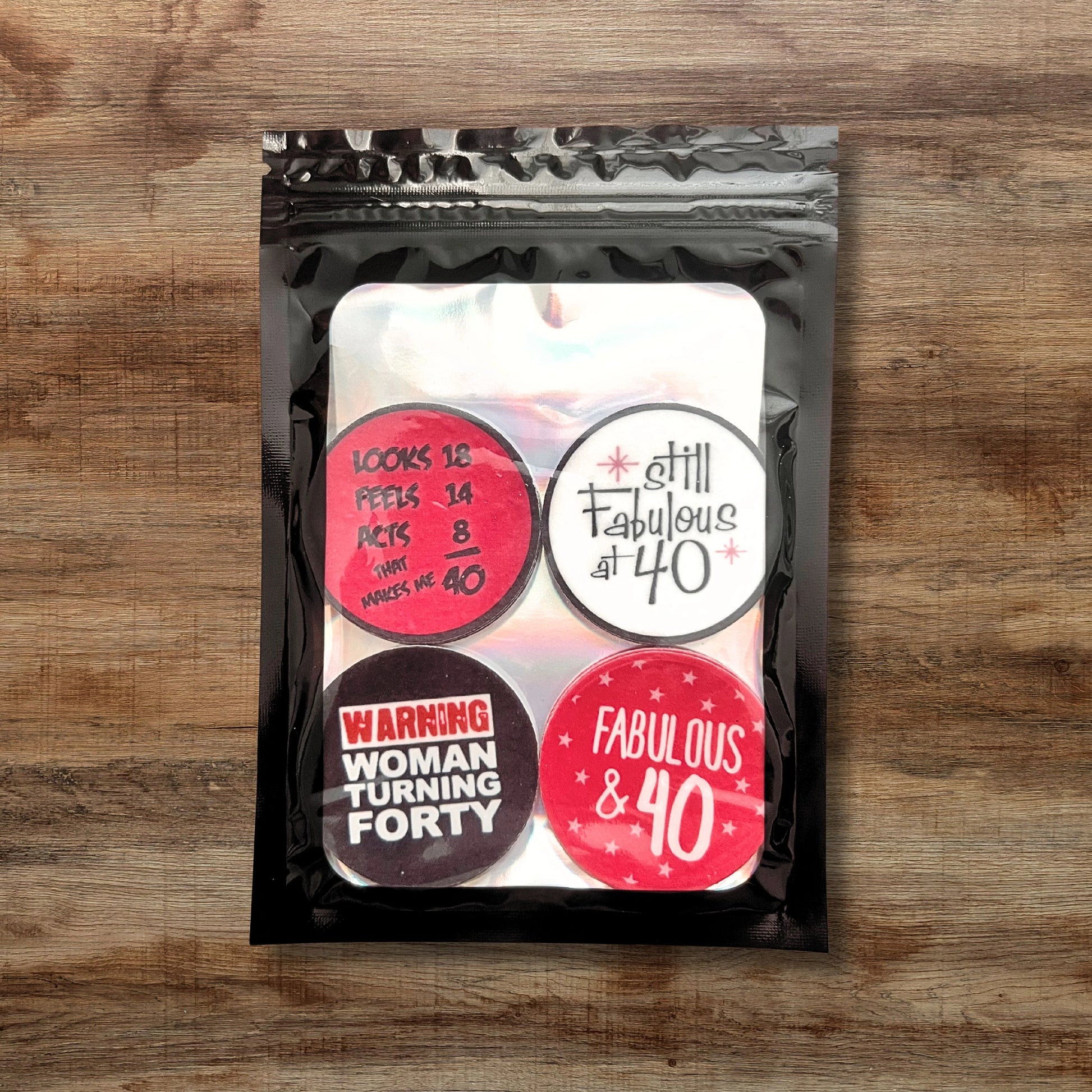 bright pink, black and white cupcake toppers with '40 and fabulous' slogans in packaging