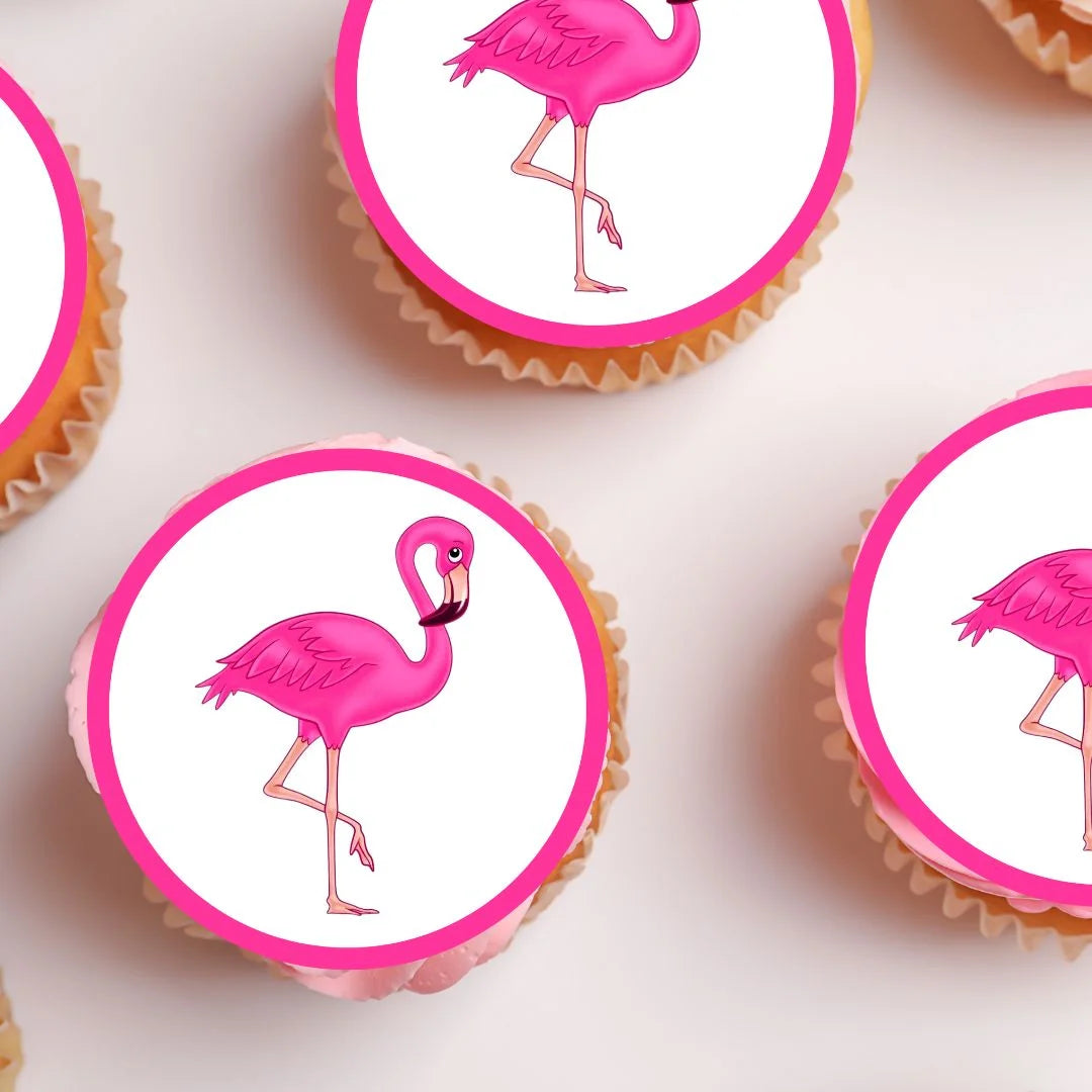 close up view of  frosted cupcakes with bright pink flamingo edible cake toppers 