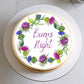 Cake with floral design and 'Burns Night' text on a white plate
