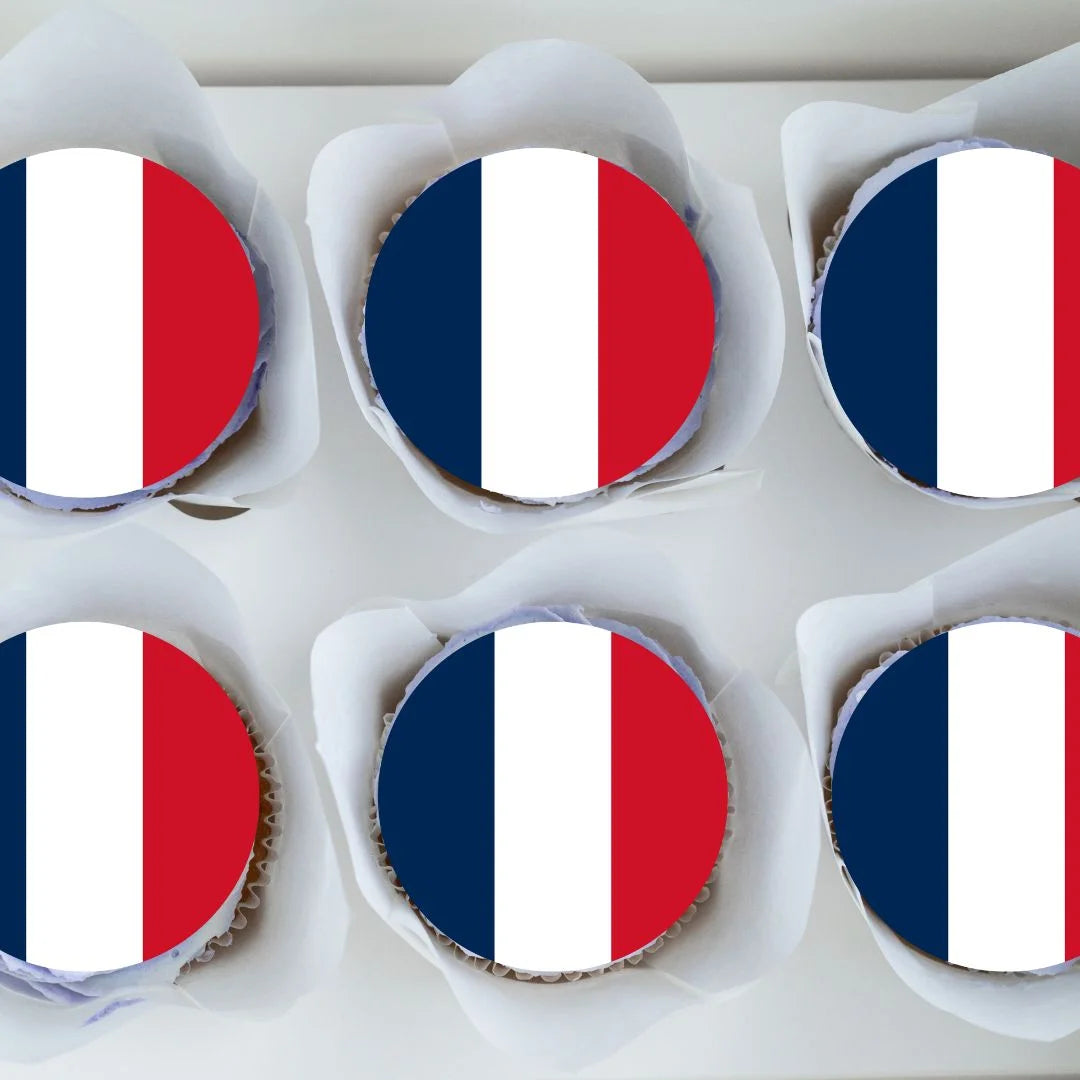 top view of French Flag Round Edible Cupcake Toppers on chocolate cupcakes with white frosting 