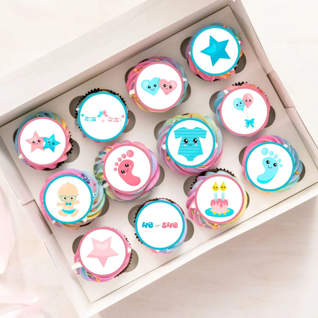 tray of rainbow frosted cupcakes topped with Gender Reveal Edible Cupcake Toppers with pink and blue illustrations