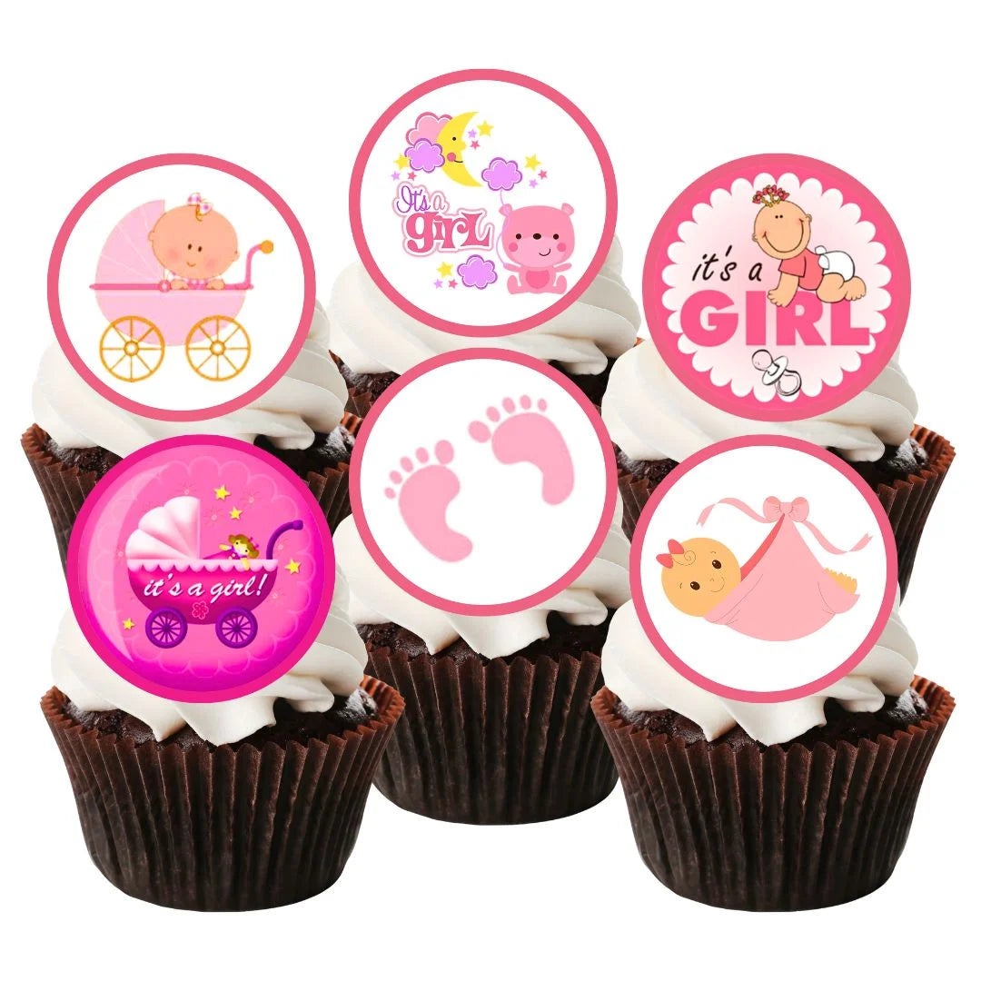 Six chocolate cupcakes with white frosting topped with It's A Girl pink Baby Shower Edible Cupcake Toppers