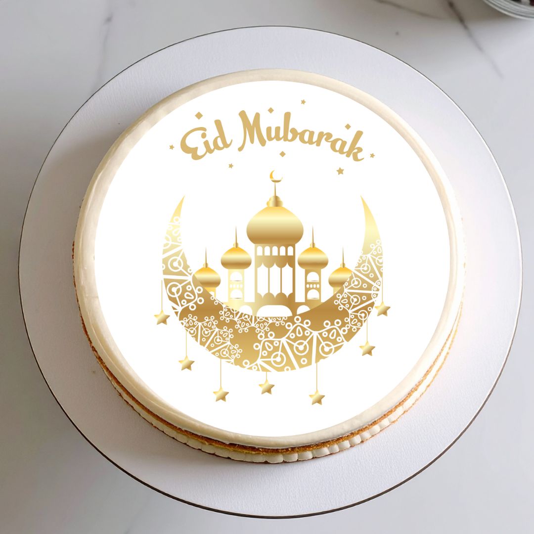 Eid Mubarak cake with gold design on a white plate