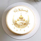 Eid Mubarak cake with gold design on a white plate