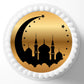 Decorative cake topper with black silhouette of a mosque and gold crescent moon on a white background
