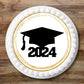 large 2024 graduation cake topper on a white iced cake 