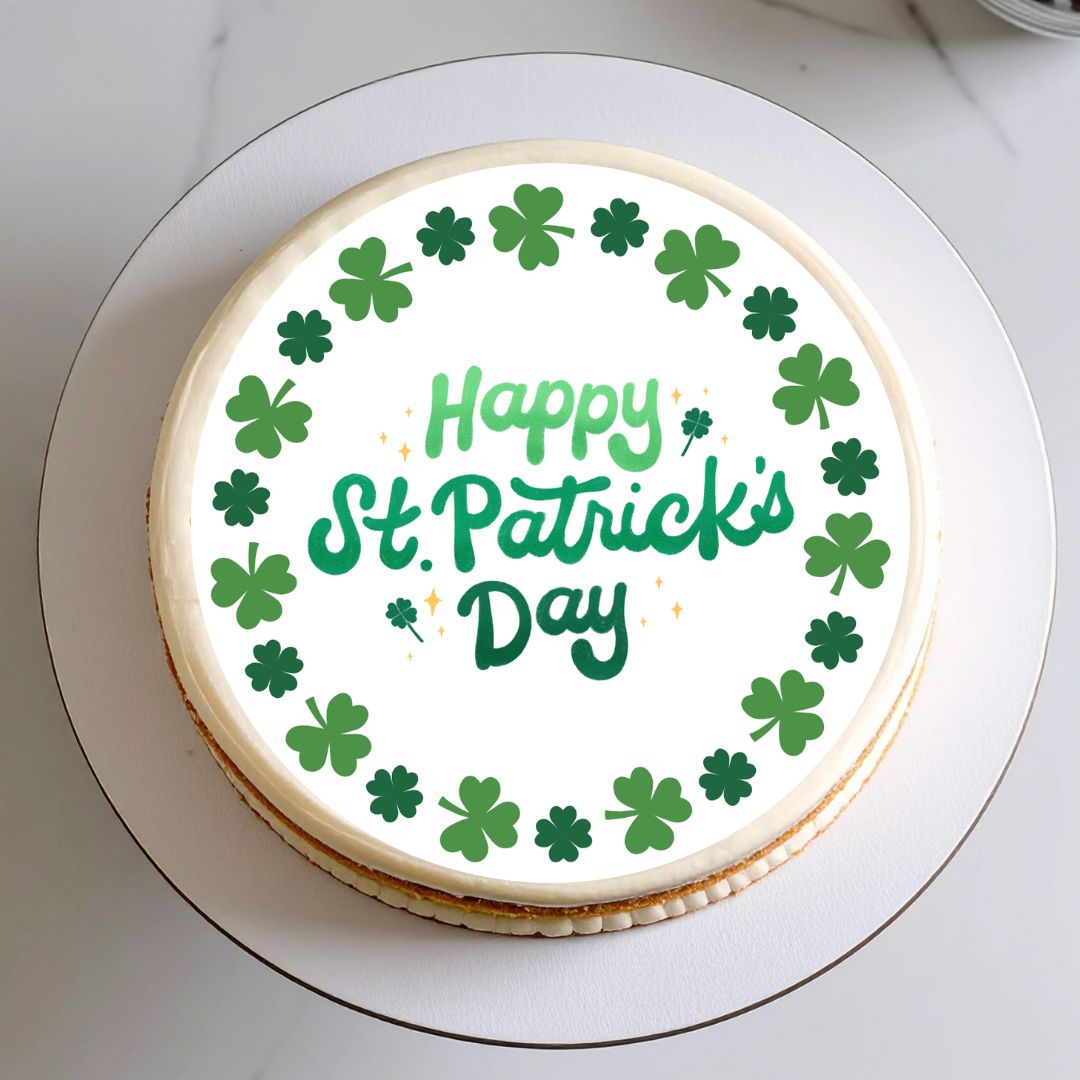 Cake with 'Happy St. Patrick's Day' text and green shamrocks on a white background