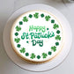 Cake with 'Happy St. Patrick's Day' text and green shamrocks on a white background