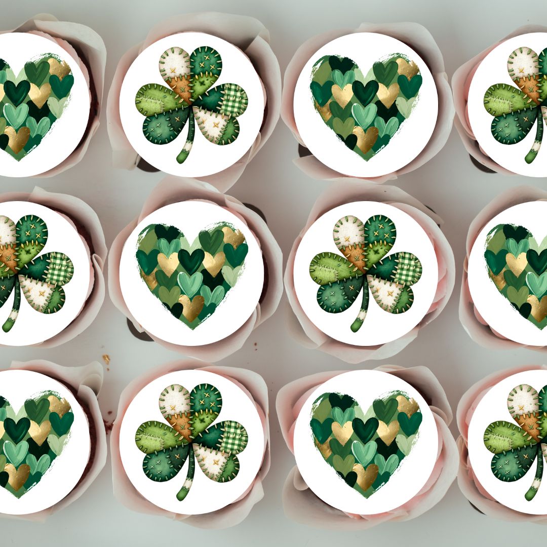 Cupcakes with green and white designs resembling shamrocks and hearts on a light gray background.