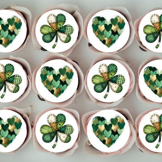 Cupcakes with green and white designs resembling shamrocks and hearts on a light gray background.