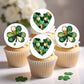 Cupcakes with shamrock and heart-shaped green decorations on white background