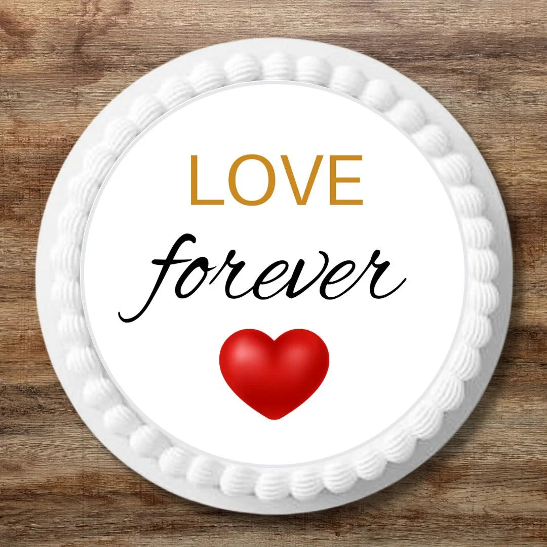 red heart "love forever" edible cake topper placed flat on a white cake