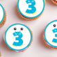 close up of Monster Theme Edible Cupcake Toppers with a blue number 3  on frosted cupcakes