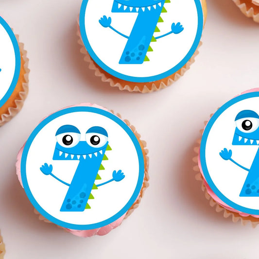 7th Birthday Monster Theme Edible Cupcake Toppers on white frosted cupcakes