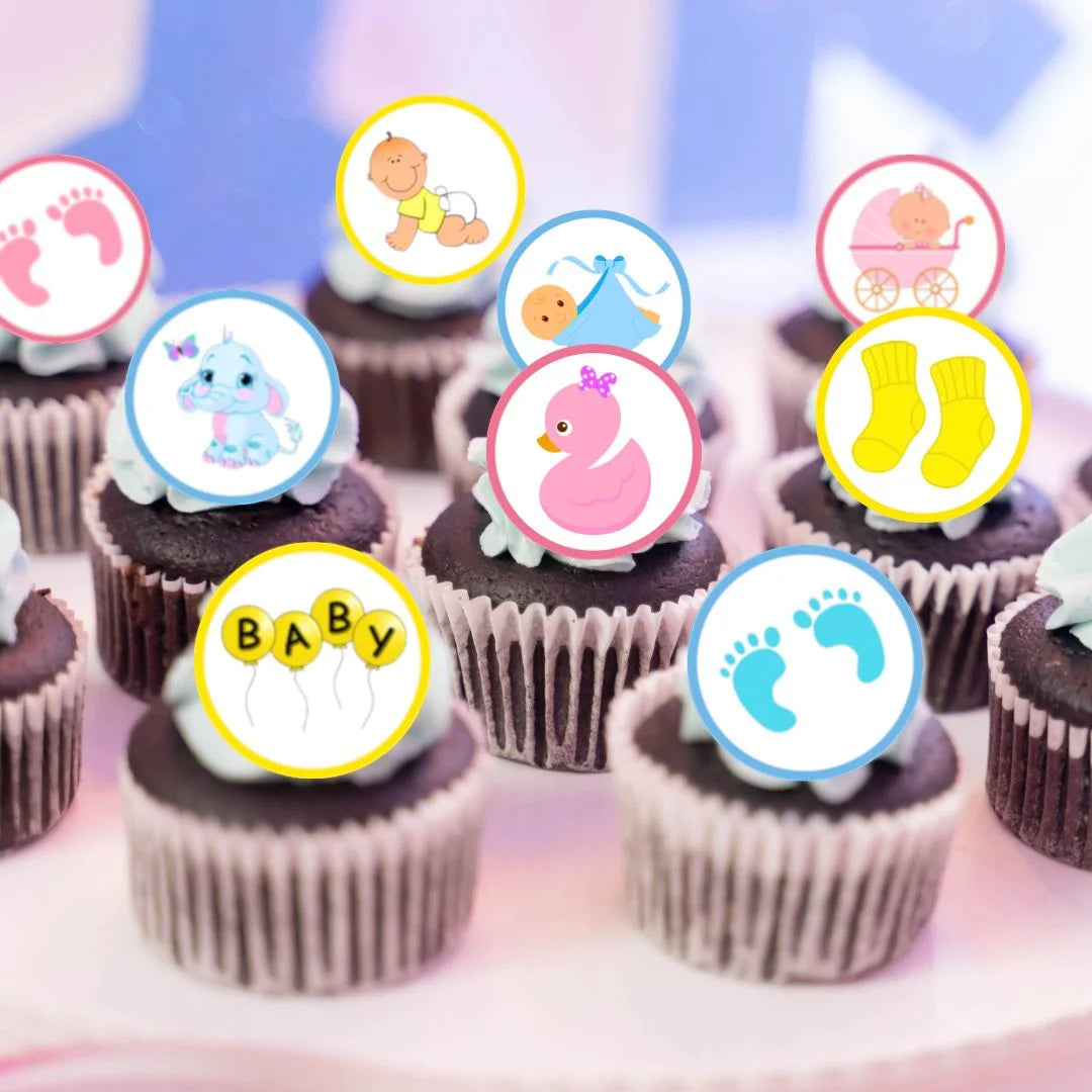 chocolate frosted cupcakes topped with pink, yellow and blue illustrated baby shower cupcake toppers