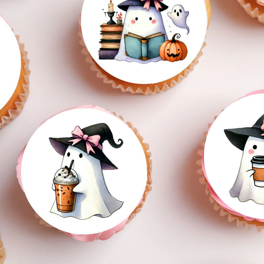 Coquette Ghost Edible Cupcake Toppers featuring a ghost wearing a witches hat. The toppers are on chocolate cupcakes with white frosting 