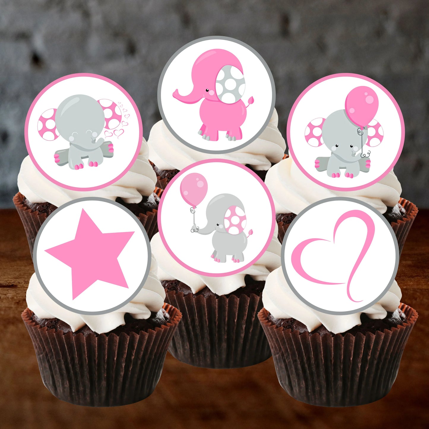 six Chocolate cupcakes with white frosting and Pink Elephant Baby Shower Cupcake Toppers