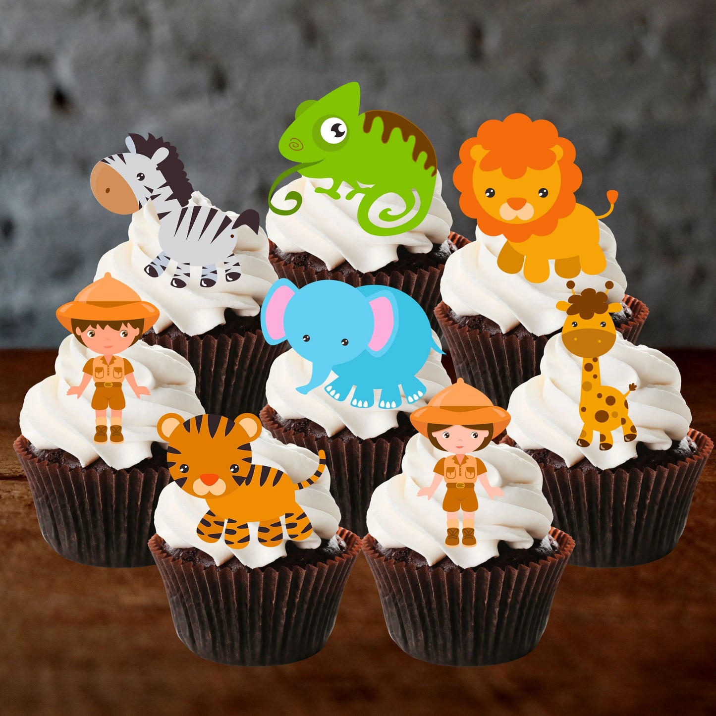 eight chocolate cupcakes with white frosting and cupcake toppers featuring safari animals and characters