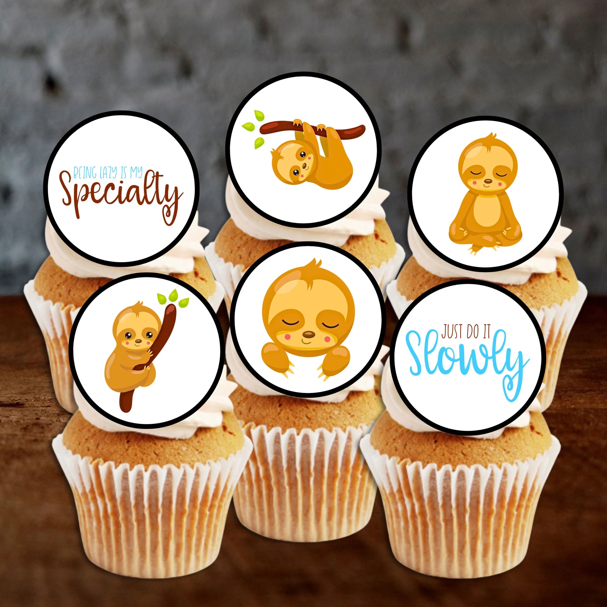 six cupcakes with white frosting and illustrated sloth cupcake toppers. 