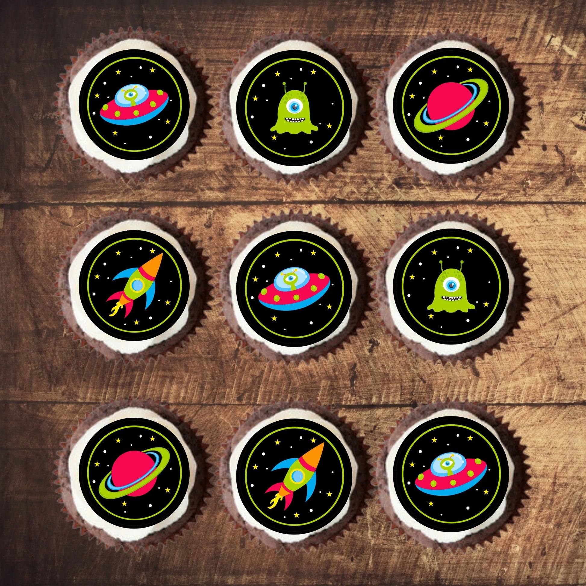 Space Theme Edible Cupcake Toppers on chocolate cupcakes toppers with white frosting 