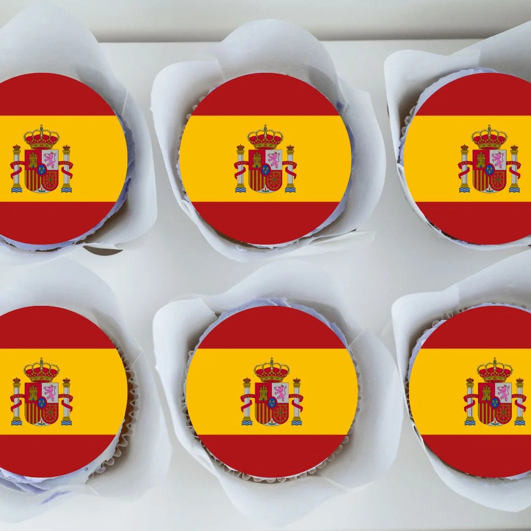 Spanish flag round edible cupcake toppers on chocolate cupcakes with white frosting