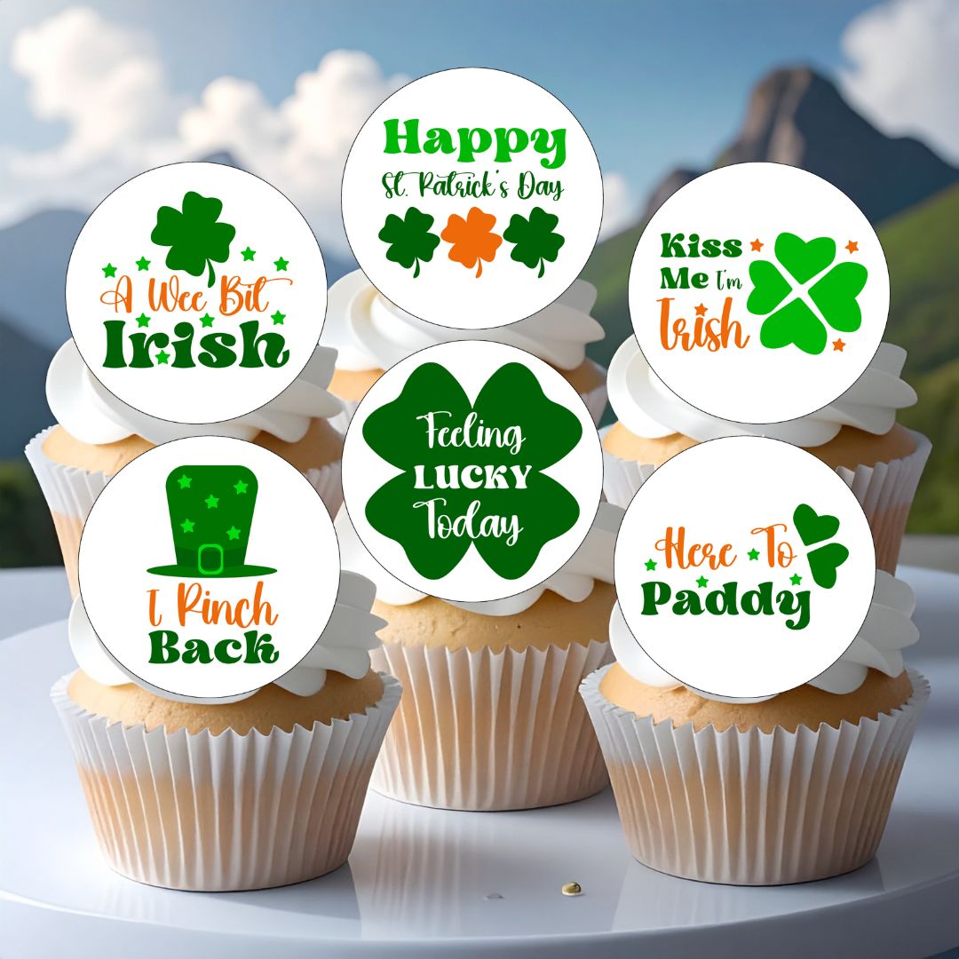 Cupcakes with St. Patrick's Day-themed toppers on a white surface with a mountain background.