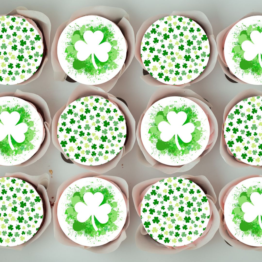 Cupcakes with green and white shamrock designs on a gray background
