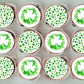 Cupcakes with green and white shamrock designs on a gray background