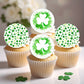 Cupcakes with shamrock-themed cupcake toppers on a light background