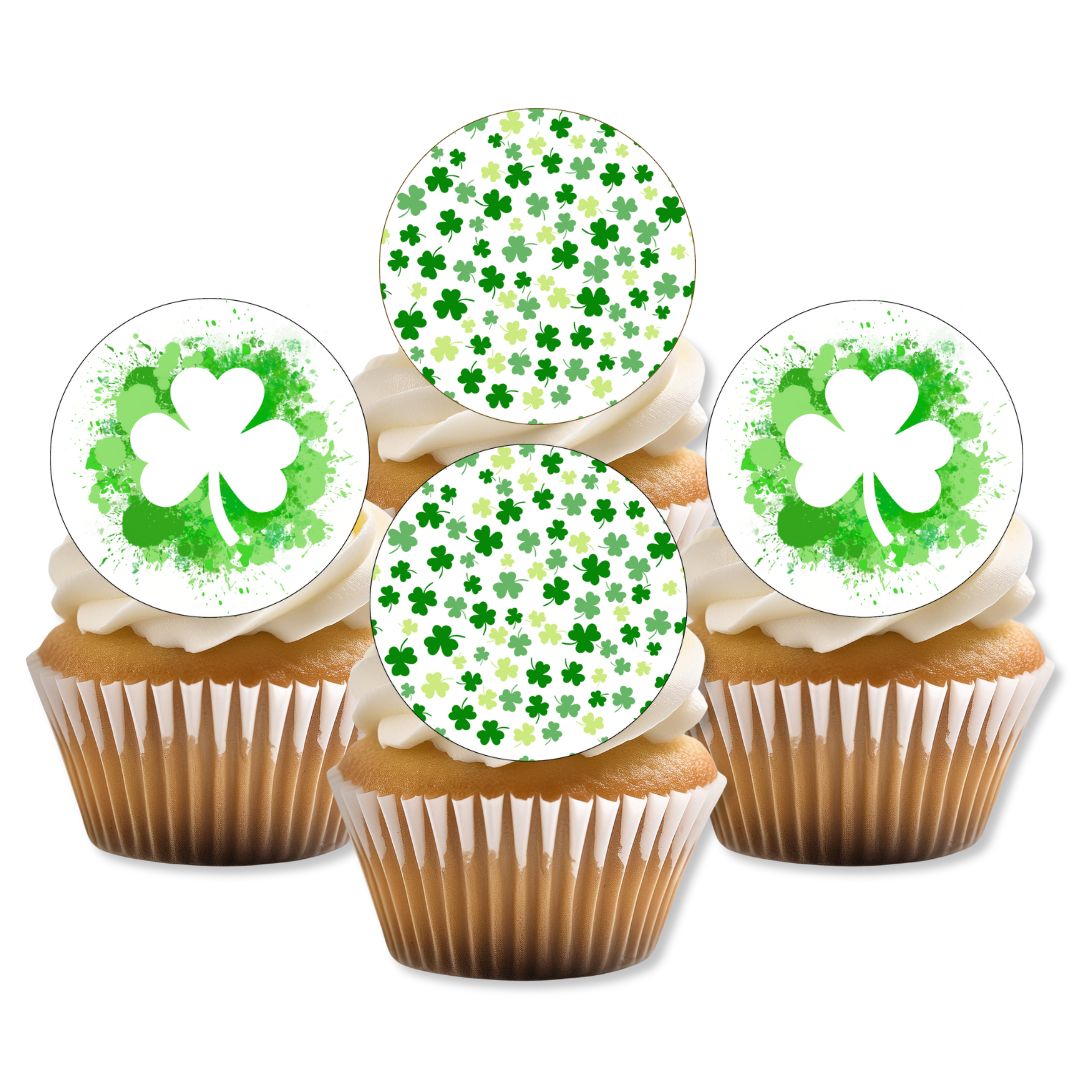 Cupcakes with white frosting and green shamrock decorations on a white background