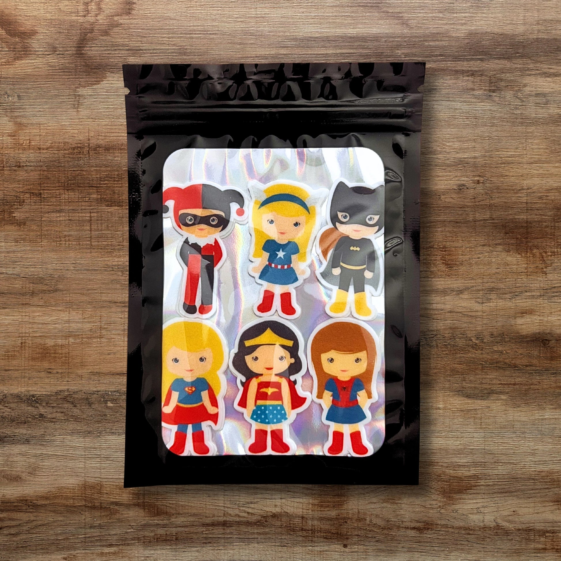 Superhero Girl Edible Cupcake Toppers on chocolate cupcakes with white frosting