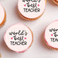 close up of Worlds Best Teacher Cupcake Toppers on pink frosted cupcakes